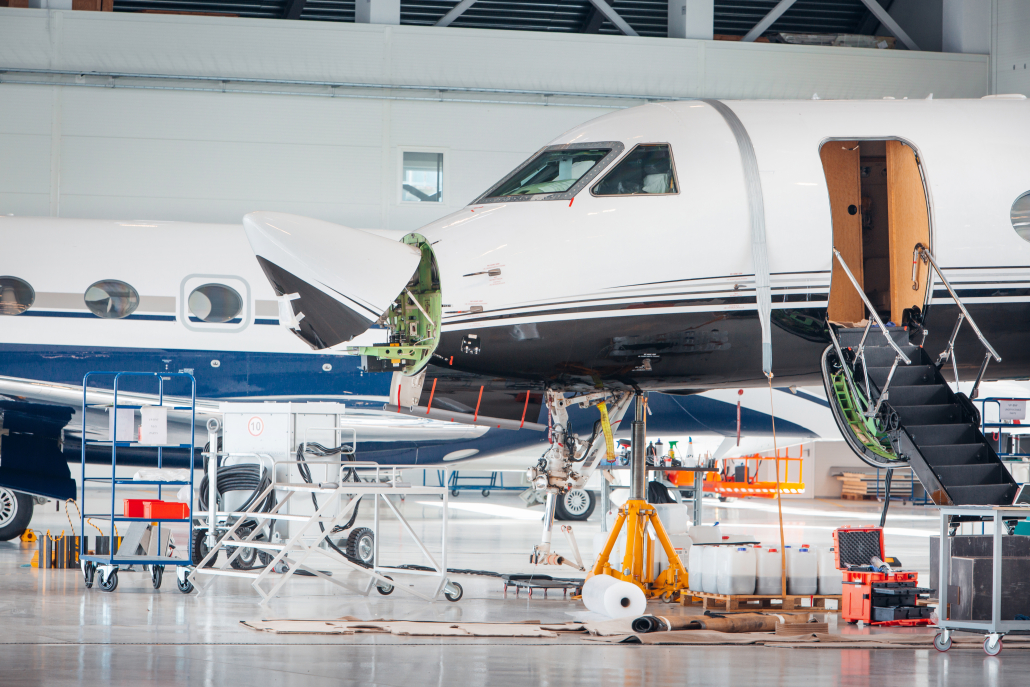 Maintenance and service check of an airplane in the large white hangar