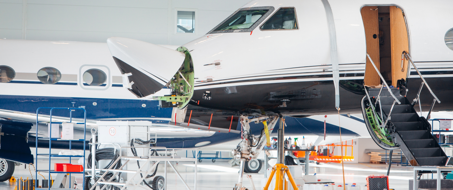 Maintenance and service check of an airplane in the large white hangar